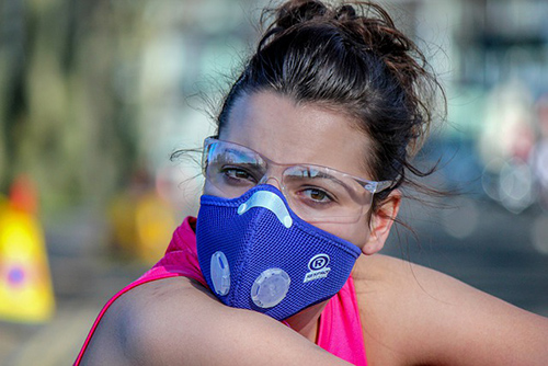 woman with glasses wearing a face mask to protect against asthma and allergies
