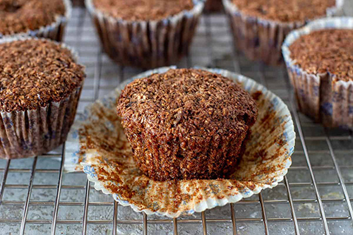 row of bran muffins sitting on tray waiting to be devoured