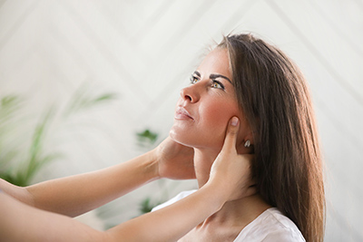 woman neck checked out by health professional