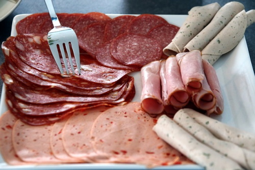 Foods that cause high blood pressure: Image of different sausages and salami slices.