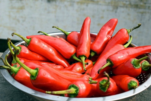 Gastritis foods to avoid: Image of bowl of red hot chili peppers.