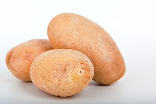 Kidney Friendly Foods: Image of three potatoes on a table.