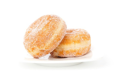 Foods that clog arteries the worst: Image of two donuts on a white plate.