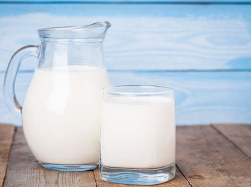 Pitcher and glass full of milk