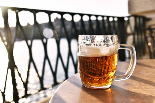 Cup of beer on the edge of a table