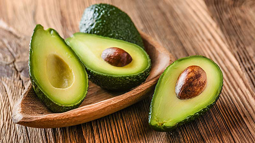 four slices of avocado waiting to be utilized by someone preparing something delicious