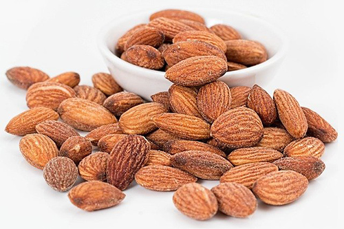 A bunch of almonds spread out on the table