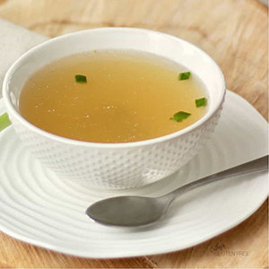 depurant broth in a white bowl and spoon next to it
