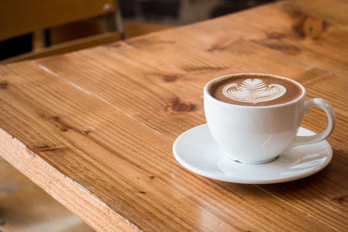 cup of coffee on a table. Coffee is a main contributor of gastritis