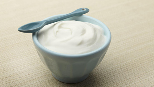 bowl of delicious yogurt with a spoon on top of the bowl