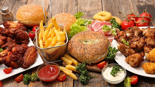 A series of high saturated fat foods all layed out on a table