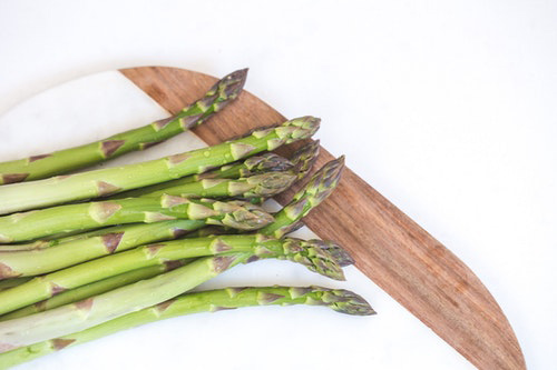 Asparagus on a cutting board ready to be prepared for a delightful meal.