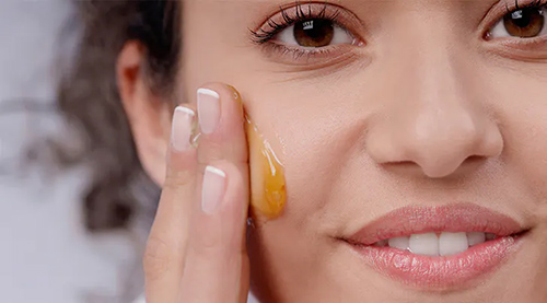 woman spreading honey on her face