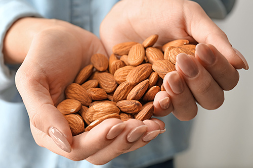 hands full of almonds