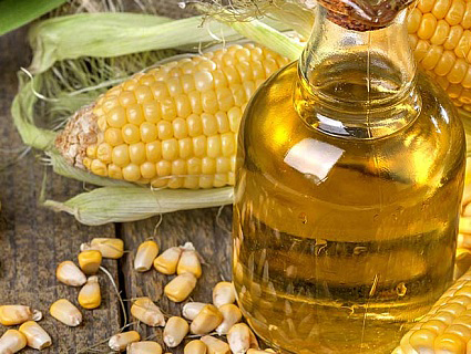 corn next to a bottle of corn oil