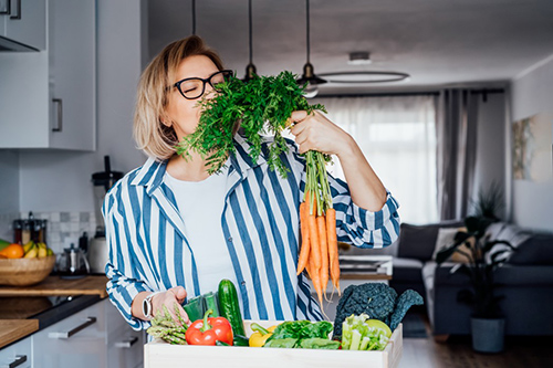 woman holding herbs that speed up metabolism