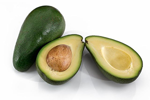two avocados with one sliced in half, which are great blood cleansing herbs