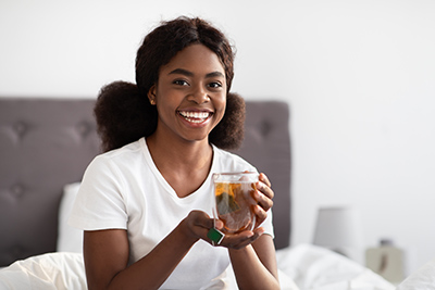 woman with cup of willow tea in her hands