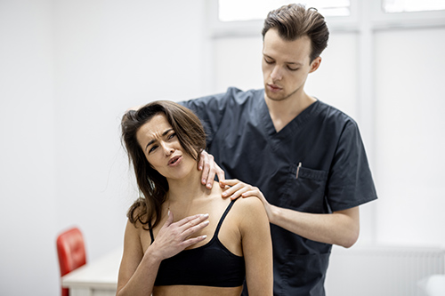woman getting treated by a doctor for musculoskeletal disorders