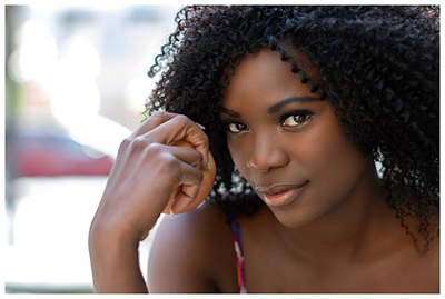 woman holding apple looking directly into the camera