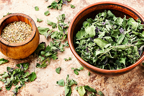 marjoram benefits with the dried leaves in bowl