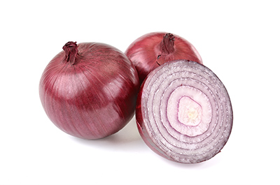 urinary system diseases: two whole onions and one cut in half on display