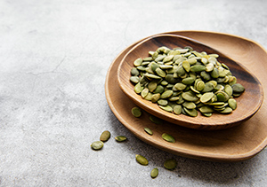 pumpkin seeds in a wooden bowl