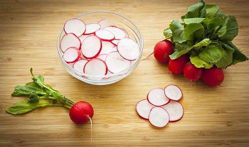 bowl of sliced radishes. Radish health benefits.