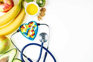 bananas with other fruit next to stethoscope in the shape of a heart