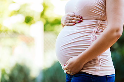 woman holding pregnant stomach