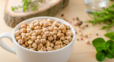 white teacup filled with chickpeas on a table