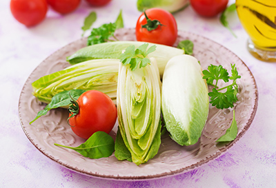 Chicory on a plate with tomatoes