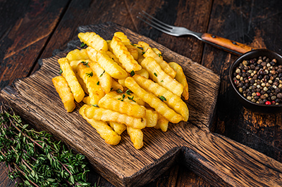 french fries on a wooden paddle