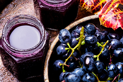 grapes with jars of grape juice