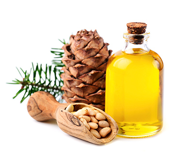 pine nuts with a glass bottle of pine oil