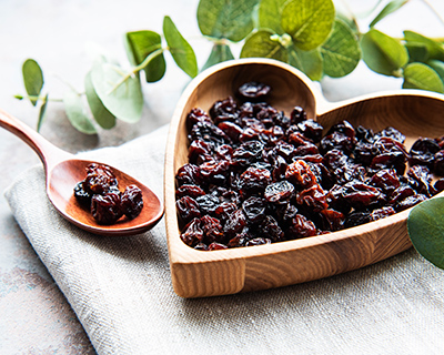 raisins in a heart shaped wooden bowl