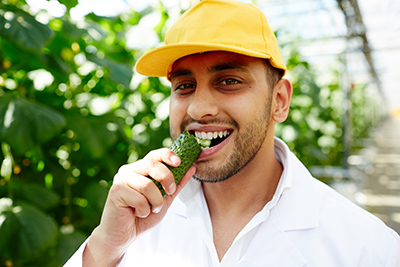 man eating cucumber