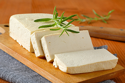 loaf of tofu with 3 slices cut