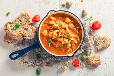 pot of stewed legumes with a whole wheat toast on the side