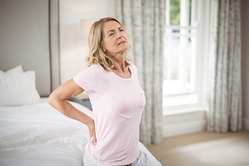 woman holding her back in chronic pain