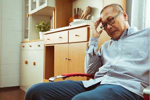 elderly man sitting suffering with incontinence