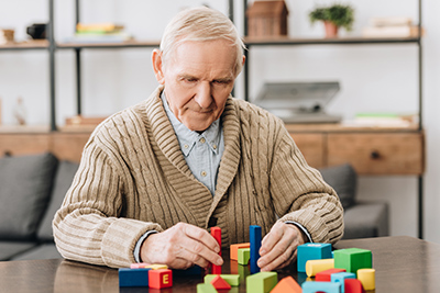 old man playing cognitive games for memory loss prevention