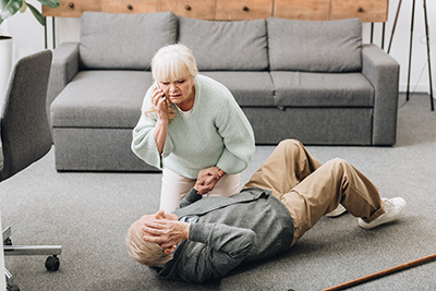 elderly woman taking care of elderly man that fell in the home