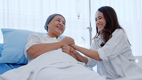 nurse holding patents hands