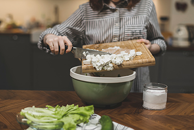 woman preparing a vegetarian meal of tofu