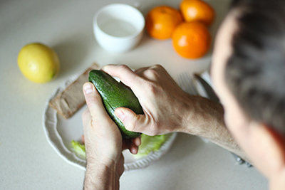 man slicing an avocado