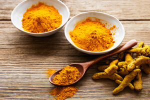 bowl of turmeric powder on a table