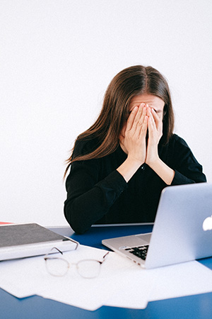 woman getting a headache after watching computer screen for long periods