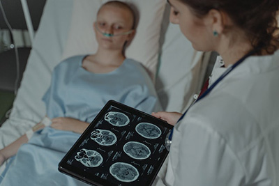 doctor explaining x-rays to patient laying in the bed