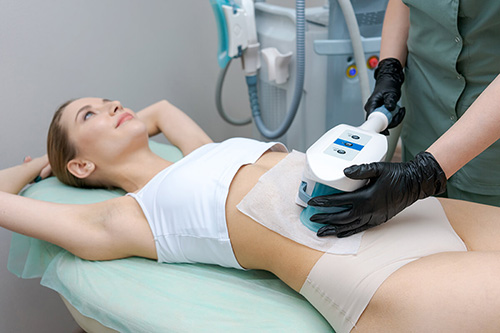 Woman receiving coolsculpting to get rid of extra fat